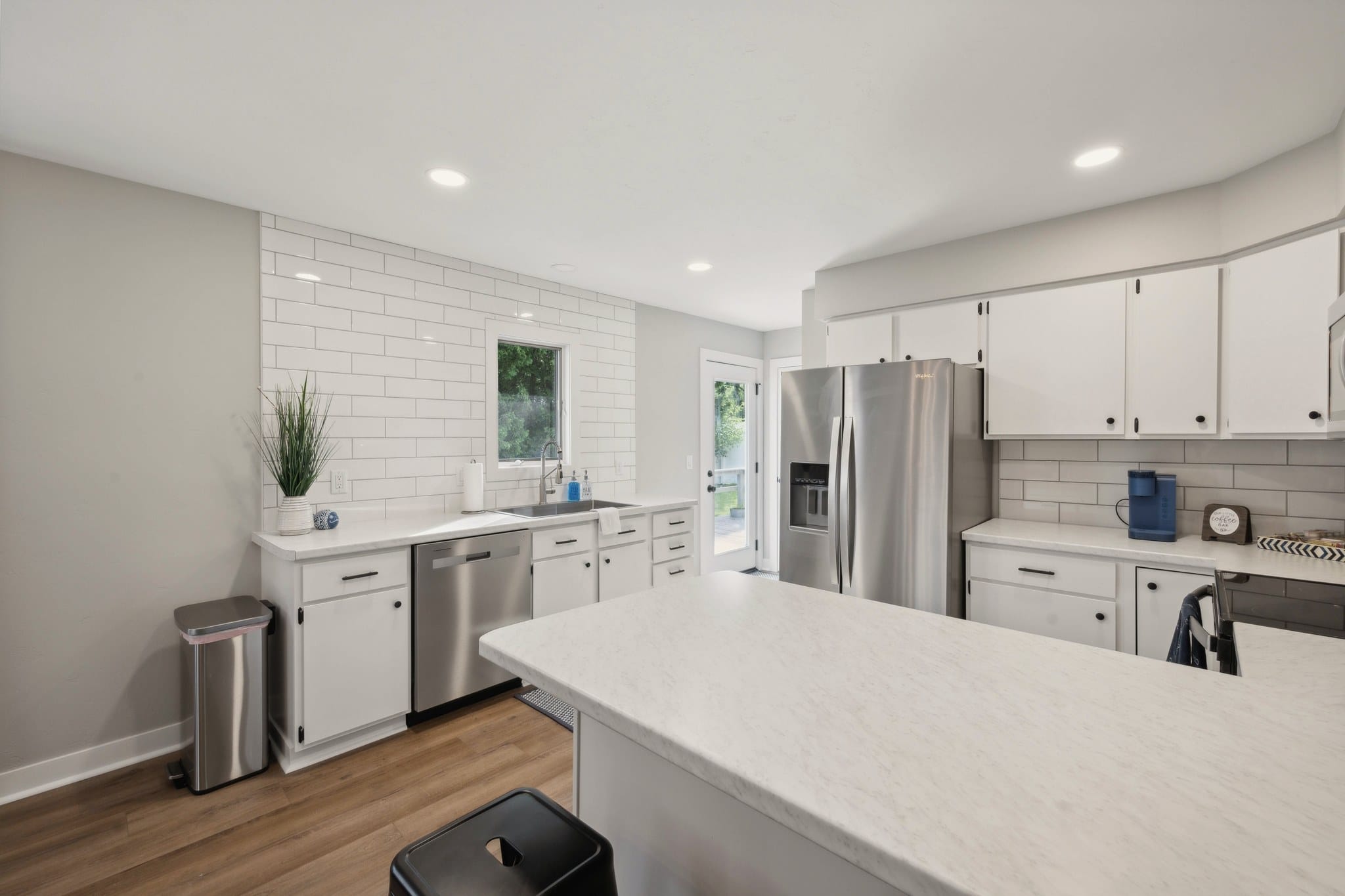 Serenity on Strauss kitchen with white subway tile and stainless appliances.