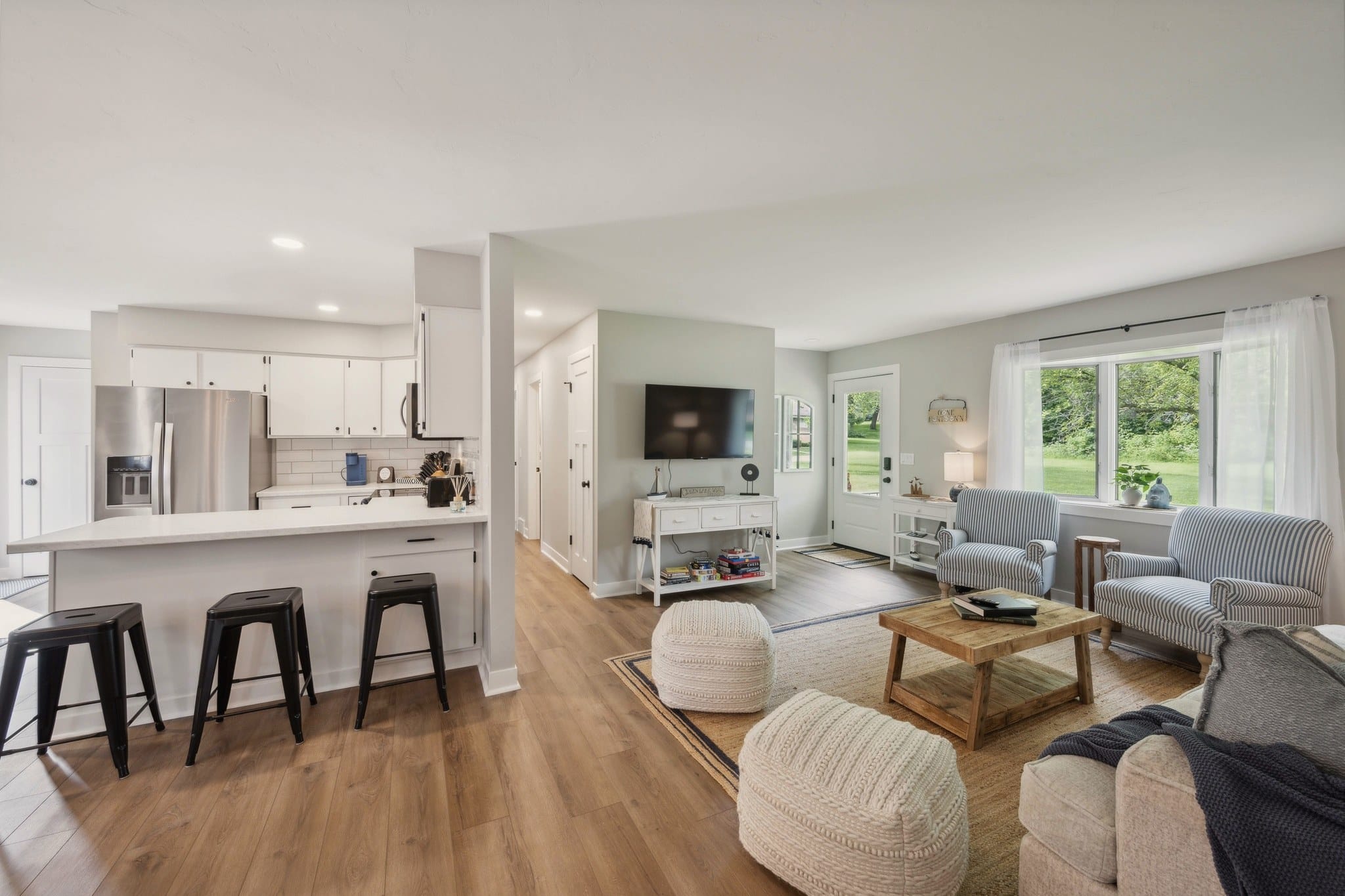 Open-plan living room and kitchen at Serenity on Strauss 400, with island seating.